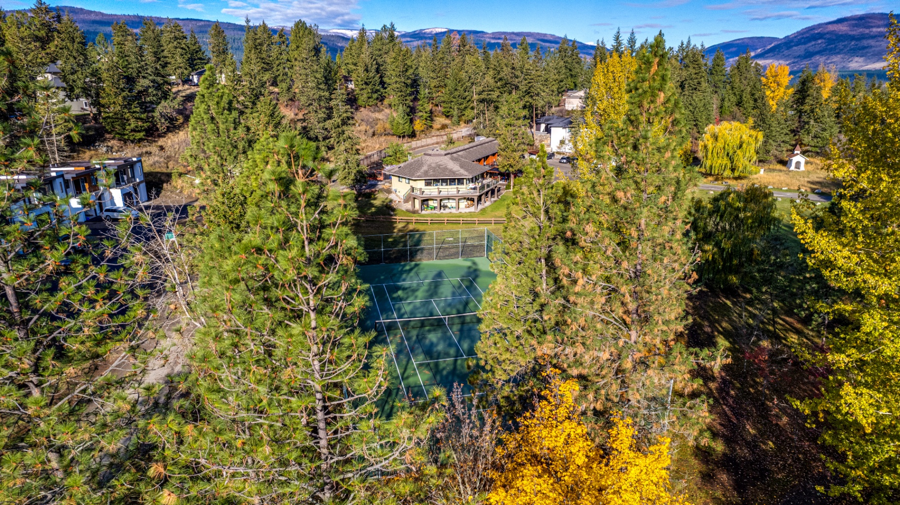 Aerial view of The Haven showing tennis court and lake views