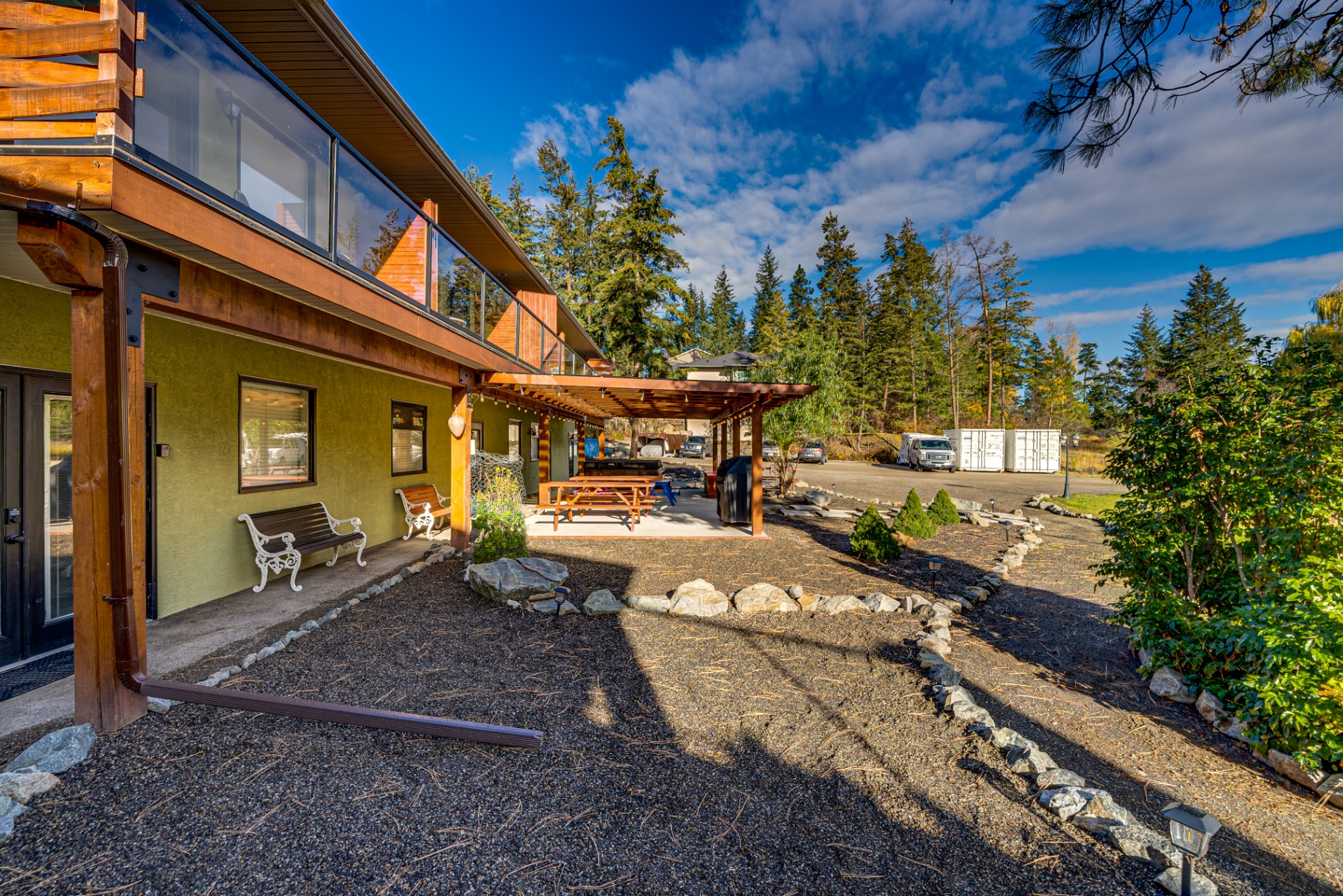 Outdoor hot tub area with covered patio and landscaping