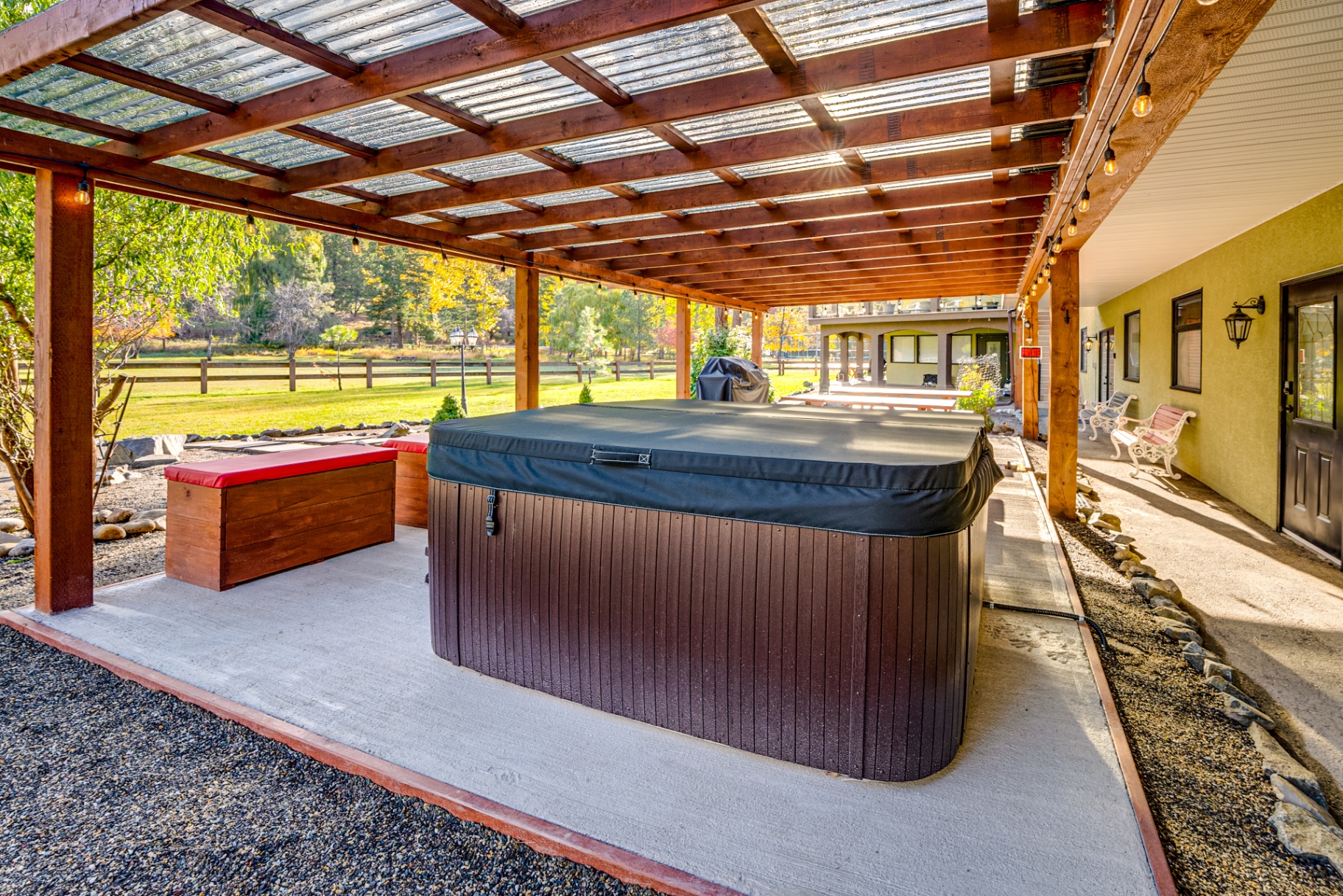 Hot tub under covered structure with mountain views