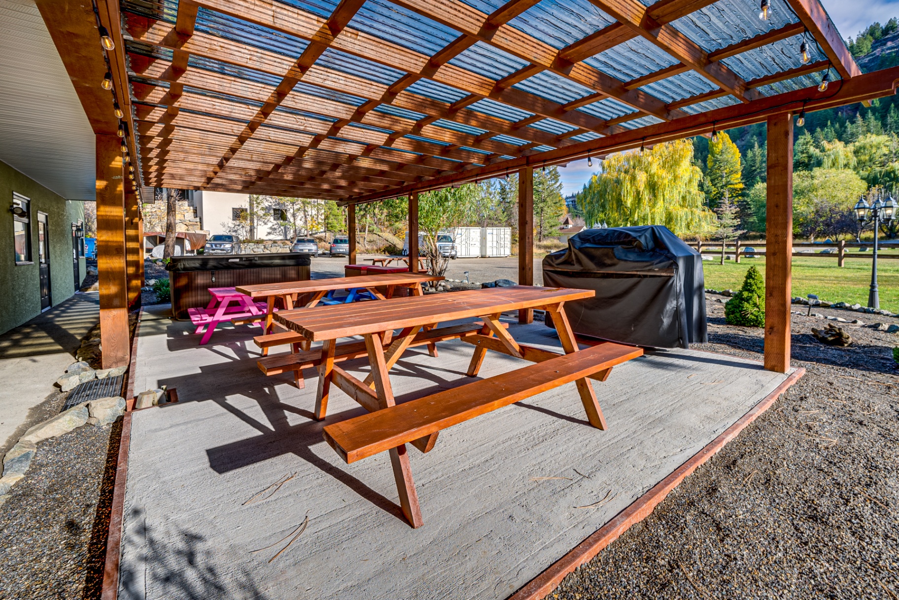 Covered dining area with wooden picnic tables